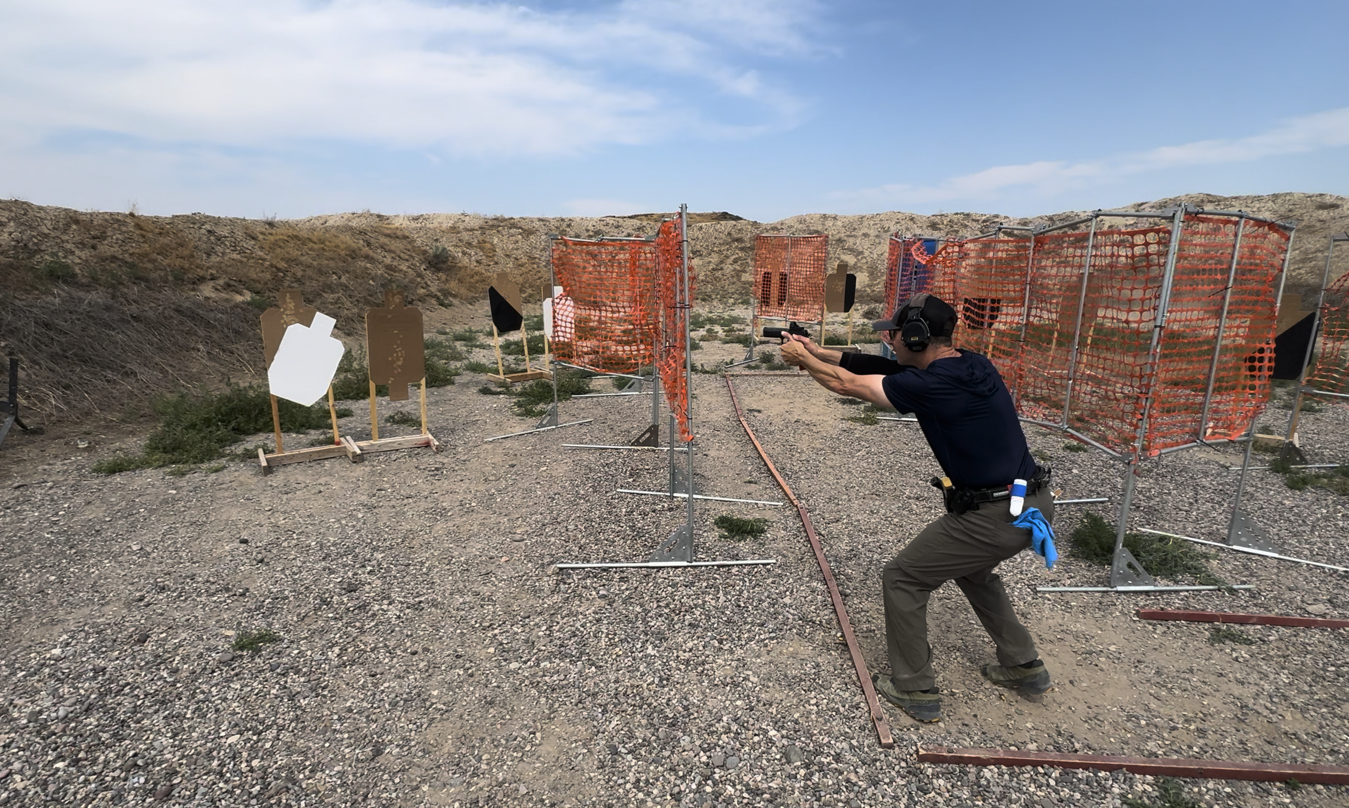 a competitor engages targets at a USPSA match